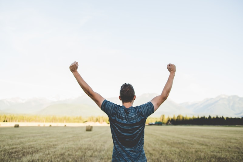 A person reaching their arms up high in celebration